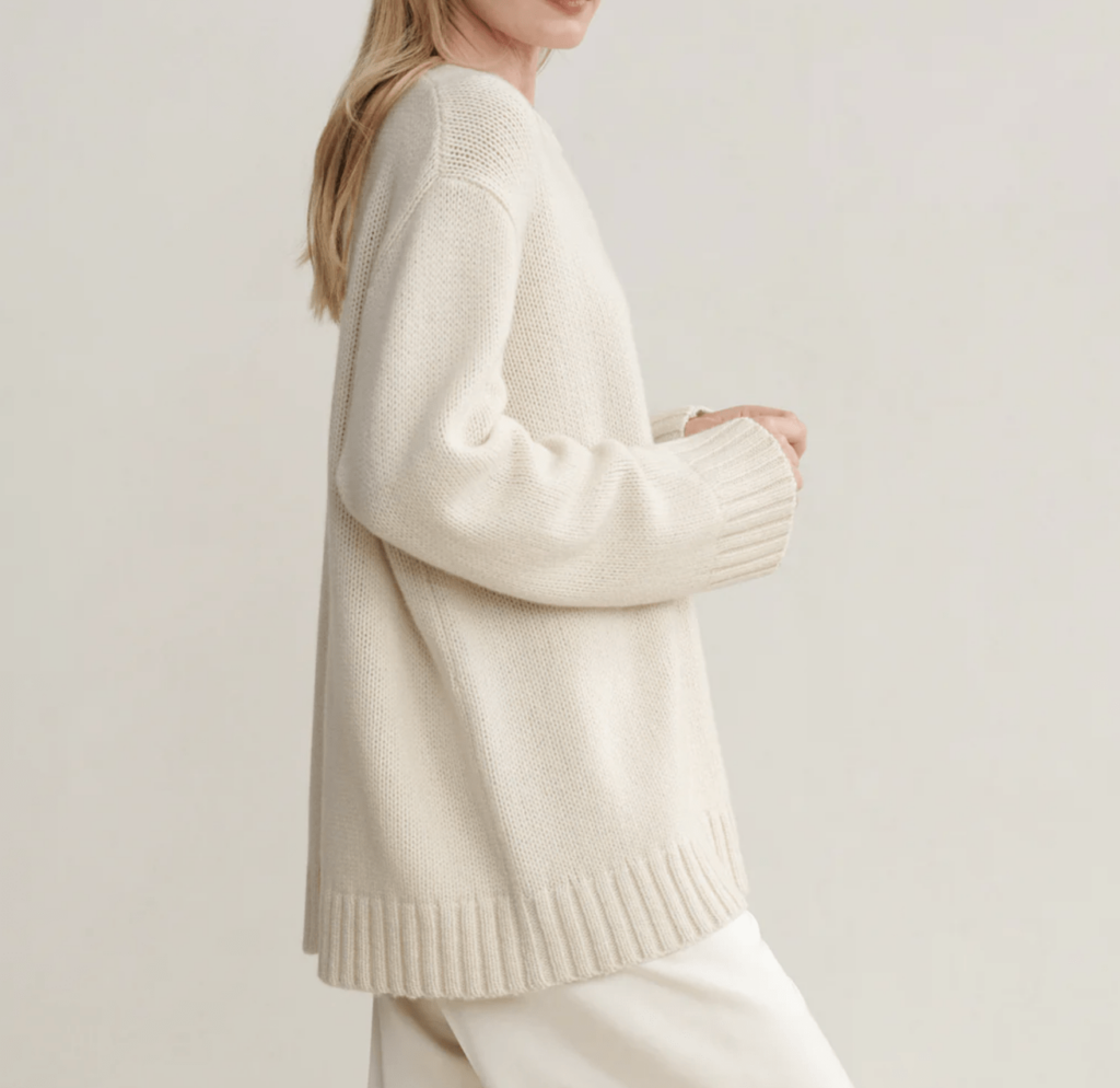 model with blond hair wearing white sweater and pants